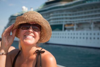 A happy woman in a hat near cruise ship dp.jpg