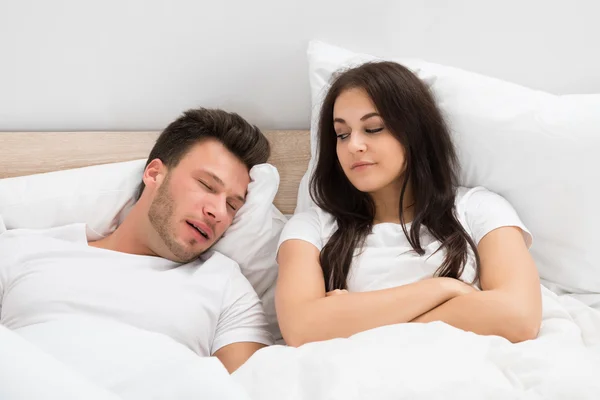 Depositphotos 74747905 stock photo woman looking at man snoring.webp.webp