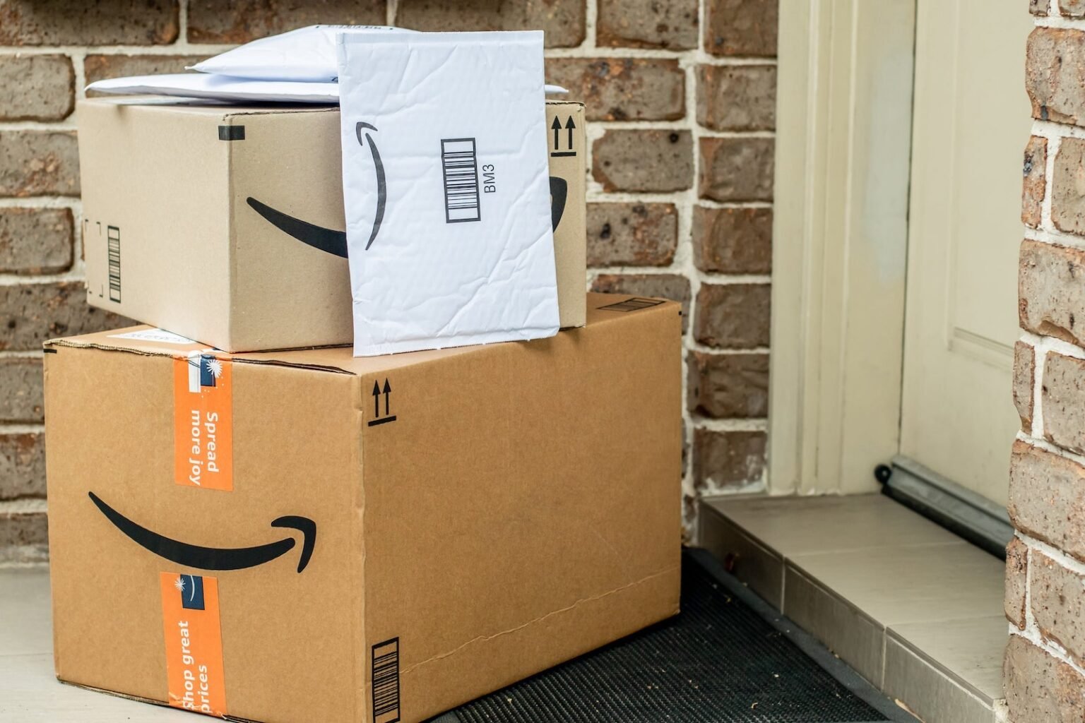 Amazon packages on a residential doorstep.jpg