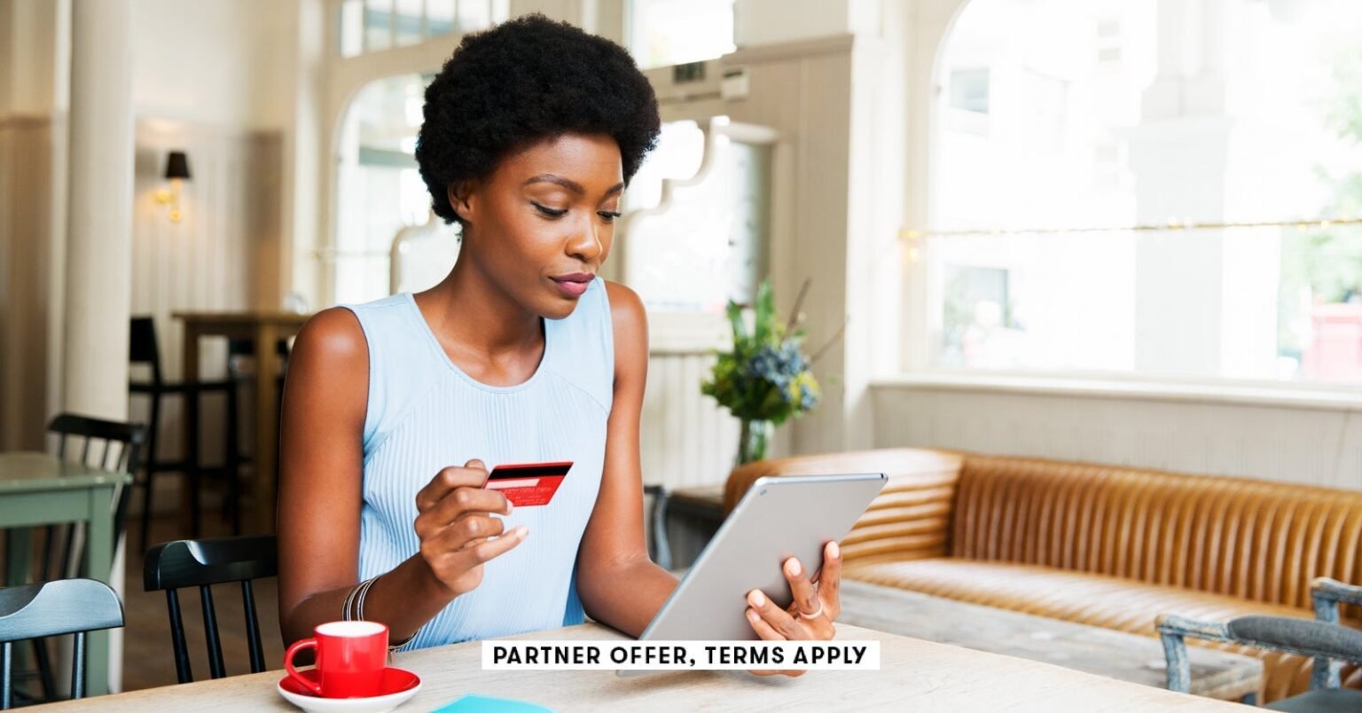 Social image partner offers terms apply person holding credit card while using tablet at cafe tim ro.jpeg