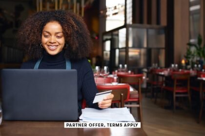 Social image partner offers terms apply restaurant owner using laptop and holding credit card southw.jpeg