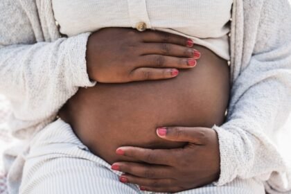 Close up african pregnant woman holding her belly focus hands 1024x683.jpg