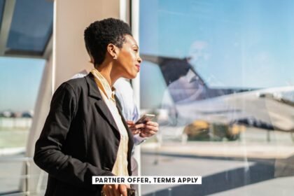 Social image partner offer terms apply ooking through the window and using smartphone in the airport.jpeg