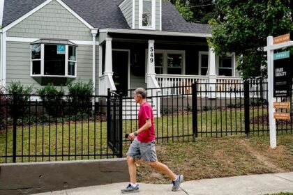 Real estate sign man walking.jpg