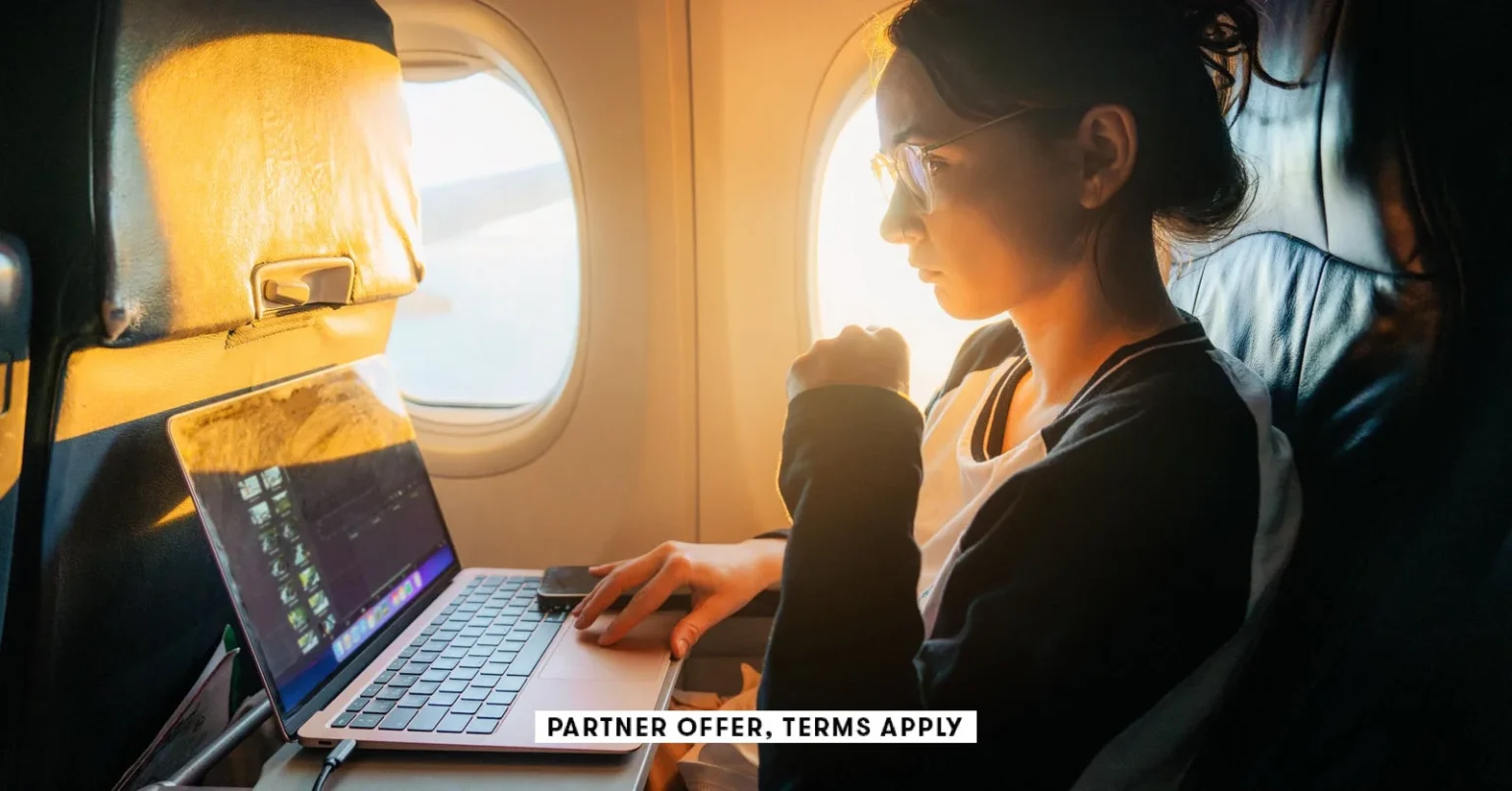 Social image partner offer terms apply woman working with laptop in the airplane oleh slobodeniuk 24.webp