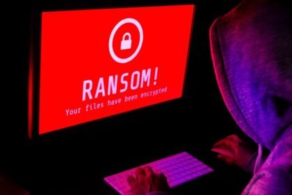 Ransomware on computer with hacker.jpg