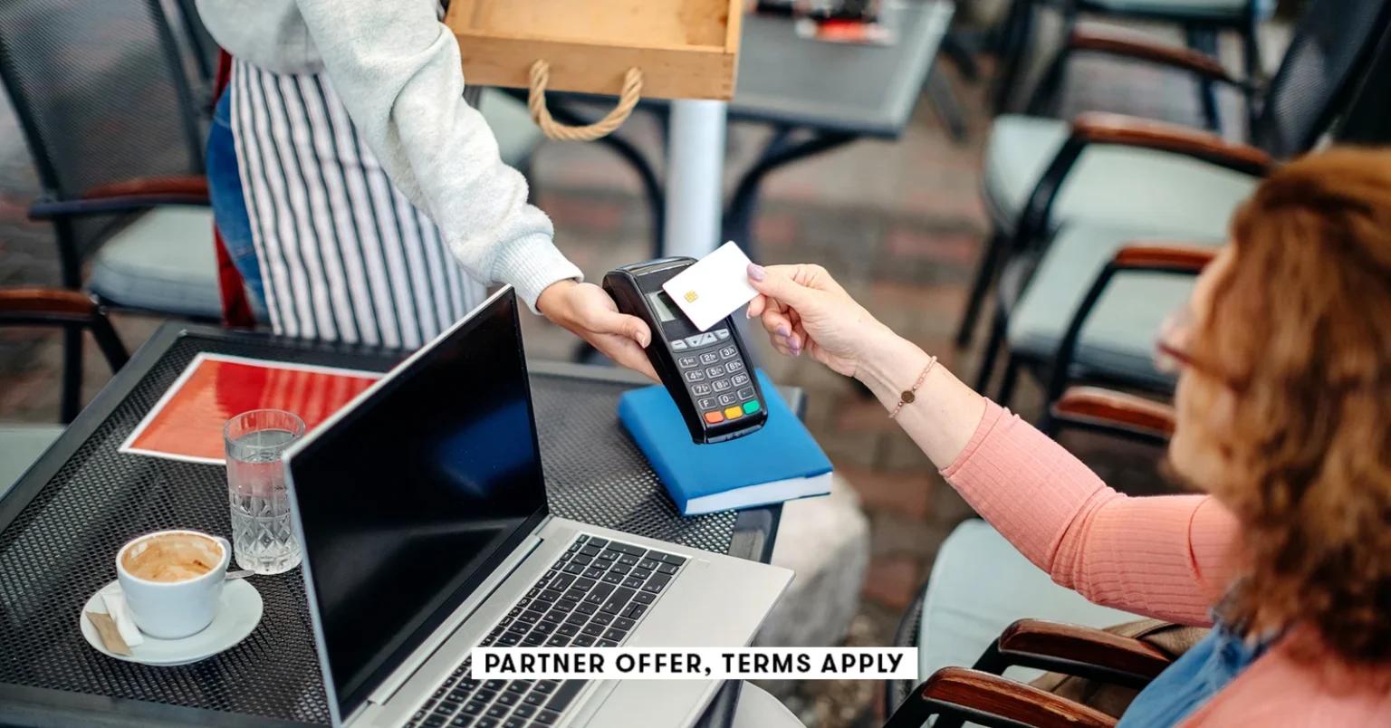 20250715 SOCIAL DISCLAIMER PARTER OFFER TERMS APPLY waitress holding credt card reader for customer.webp