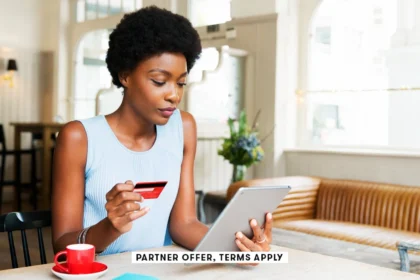 SOCIAL IMAGE PARTNER OFFERS TERMS APPLY Person holding credit card while using tablet at cafe Tim Ro.webp