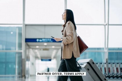 Young womanc walking throught airport with suitcase d3sign SOCIAL.jpg