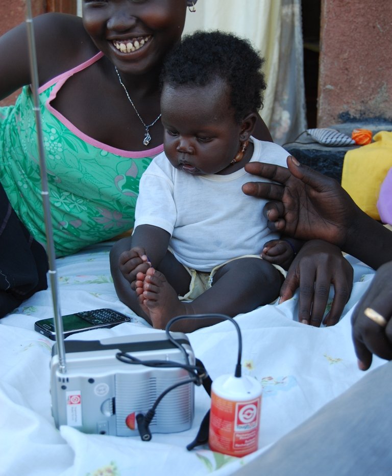 Woman and child with sunlife radio.jpg