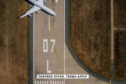 20250715 SOCIAL DISCLAIMER PARTER OFFER TERMS APPLY Birds eye view of airplane parked on airport run.webp