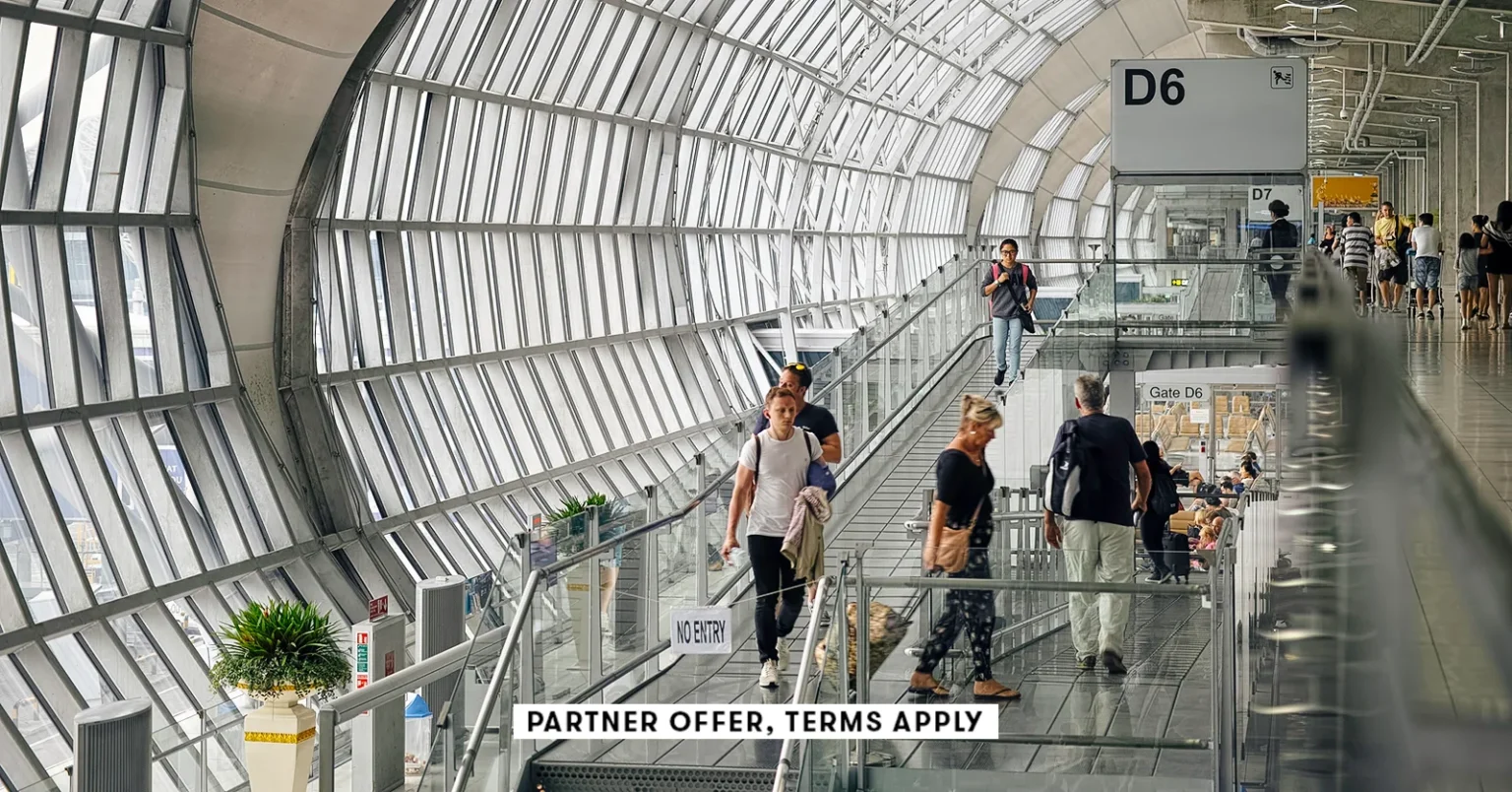 20250715 SOCIAL DISCLAIMER PARTER OFFER TERMS APPLY Passangers walking through deaprture gate at Suv.webp