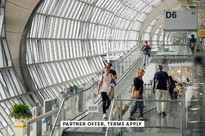 20250715 SOCIAL DISCLAIMER PARTER OFFER TERMS APPLY Passangers walking through deaprture gate at Suv.webp