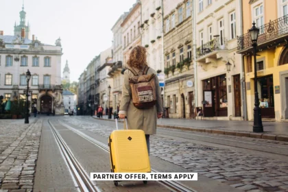 SOCIAL IMAGE PARTNER OFFER TERMS APPLY woman with a suitcase walking on European street Nazar Rybak.webp