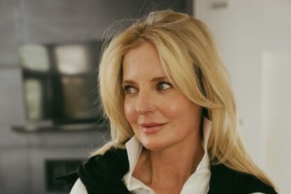 White button down sweater draped over shoulders khaite sunglasses 3.jpg