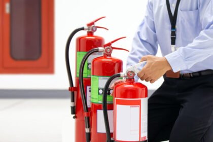 Firefighter checking handle red fire extinguisher 1024x576.jpg