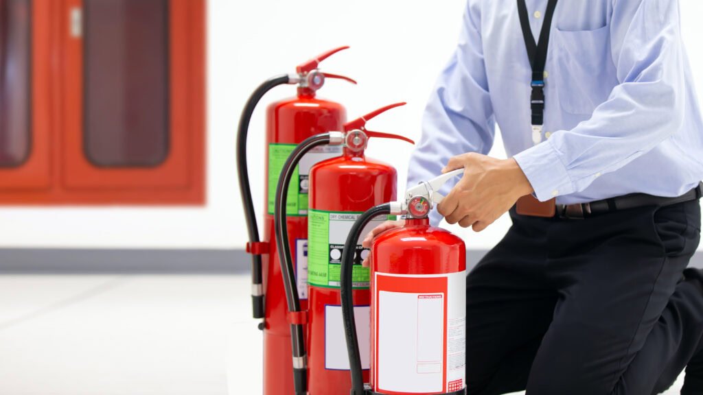 Firefighter checking handle red fire extinguisher 1024x576.jpg