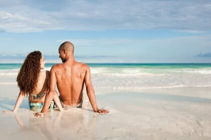 Young couple beach ocean travel vacation fun luxury.jpg